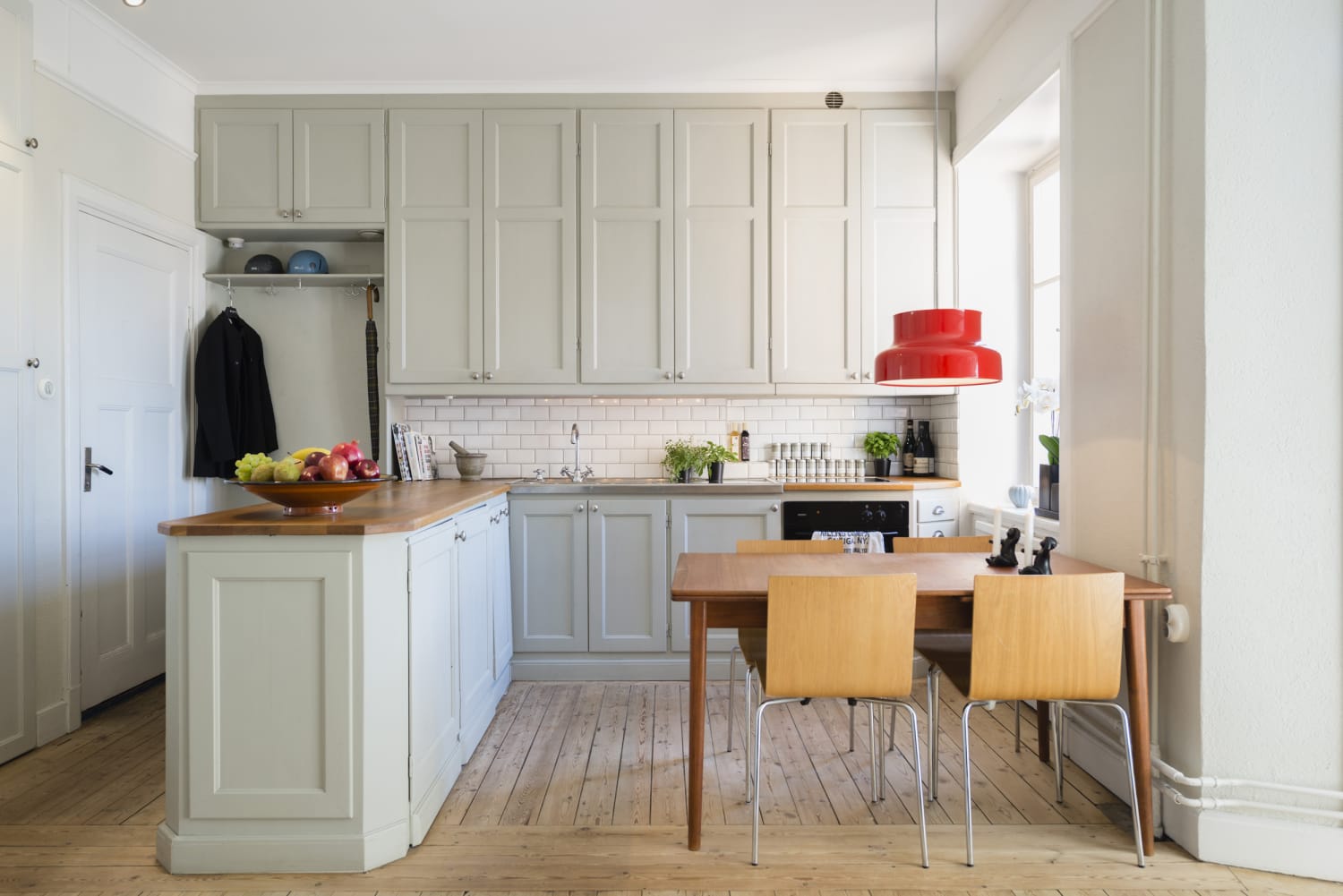 Professional cleaner wiping a bright modern kitchen counter