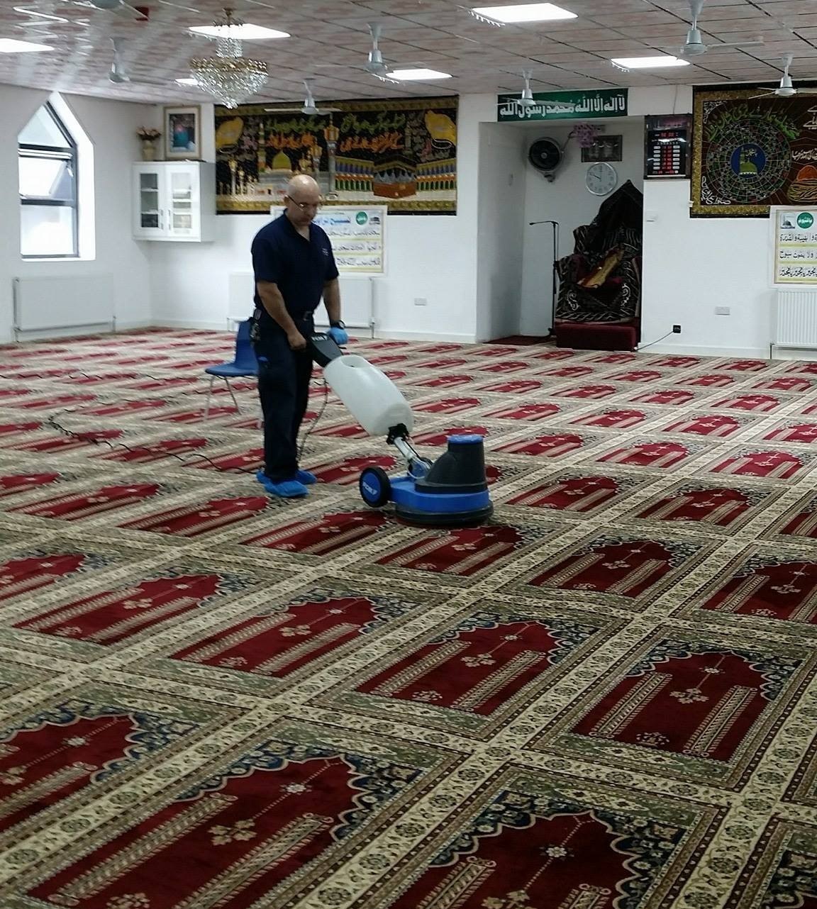 Machine cleaning the prayer hall carpet of a mosque